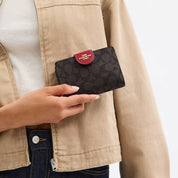 Coach Outlet Medium Corner Zip Wallet In Signature Canvas