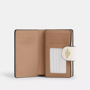 Coach Outlet Medium Corner Zip Wallet In Signature Canvas
