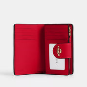 Coach Outlet Medium Corner Zip Wallet In Signature Canvas